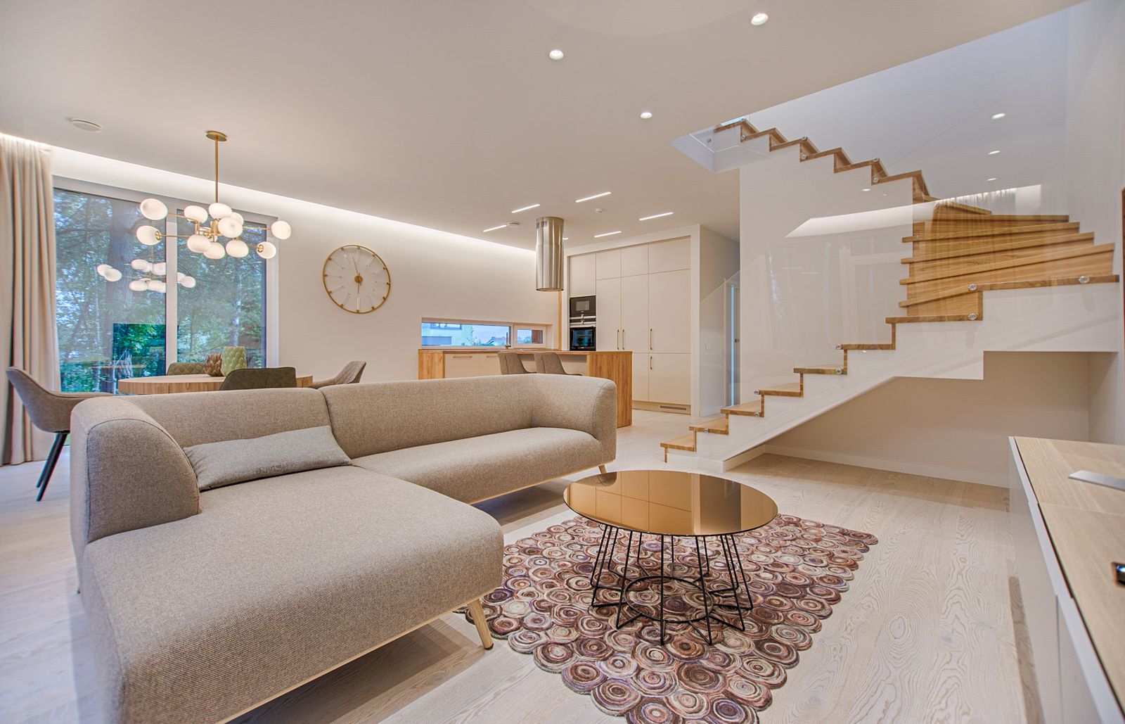A bright, immaculate open-plan St. George living room — spotless light floors, clean white walls, and a freshly tidied lounge