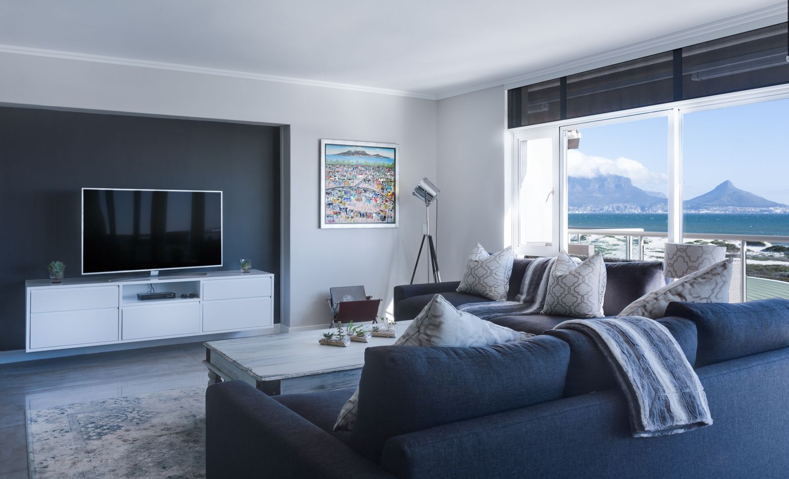 A tidied, immaculate living room with a sweeping view — vacation-rental ready